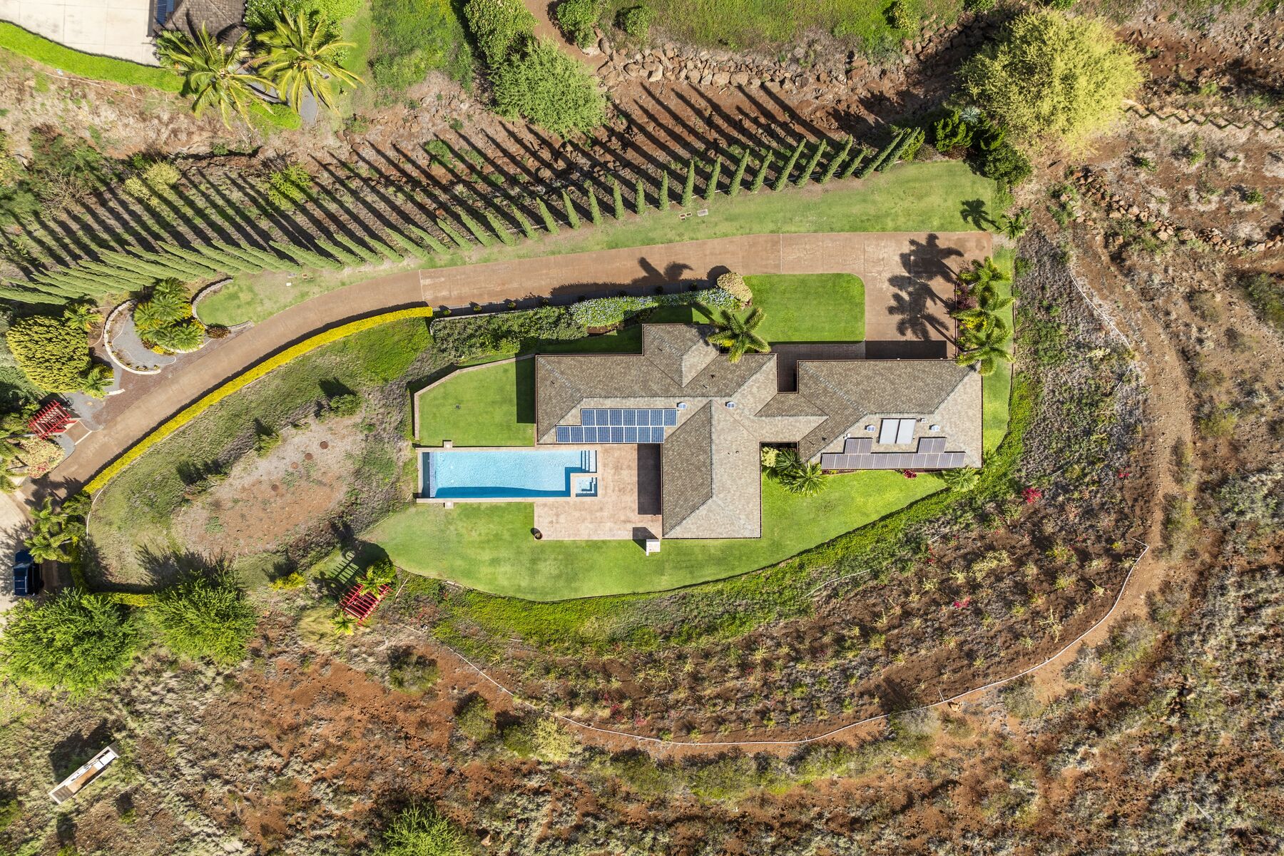 Overhead aerial of the residence, pool and cypress drive